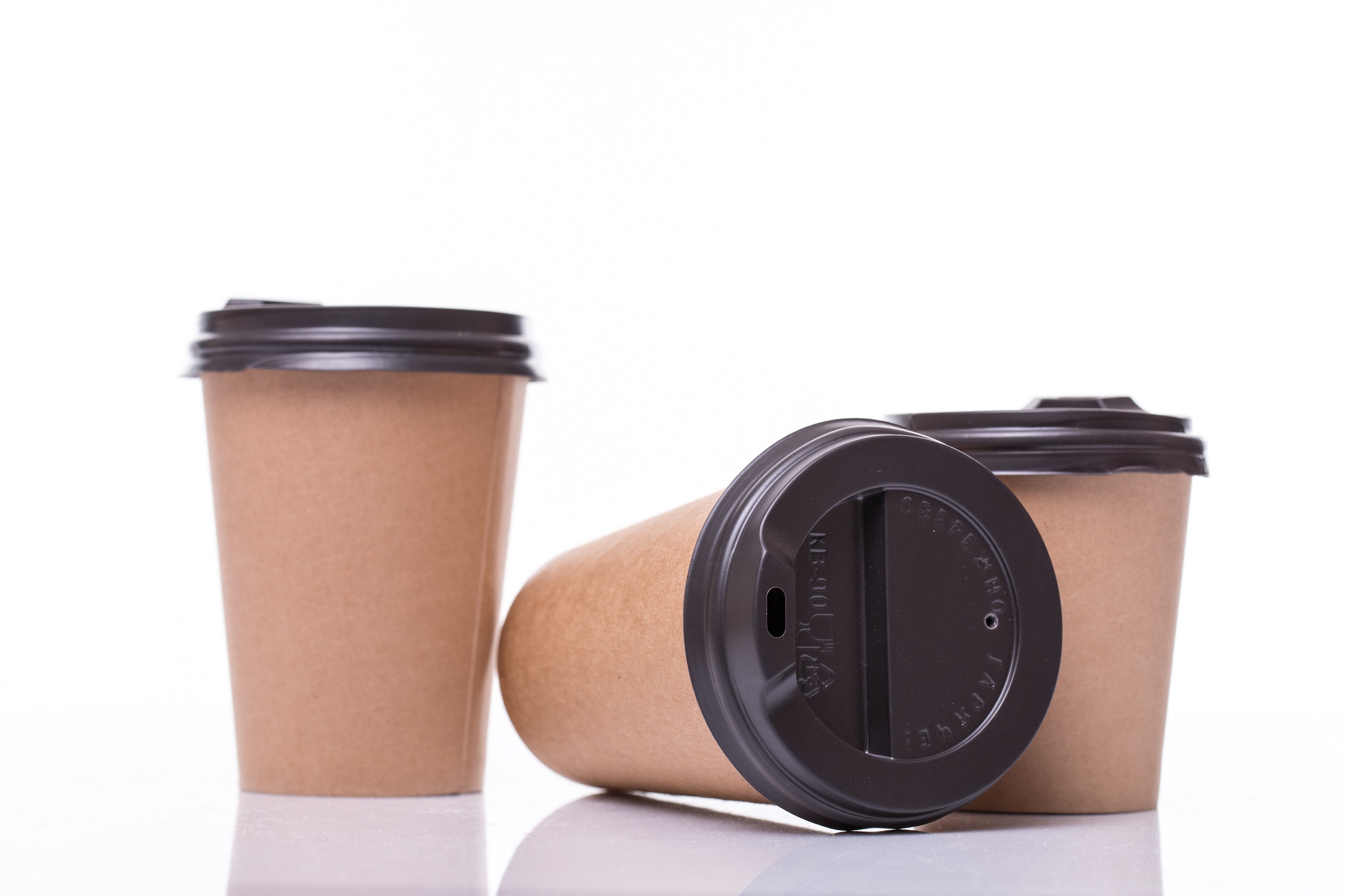 covered Paper coffee cups different sizes isolated on white