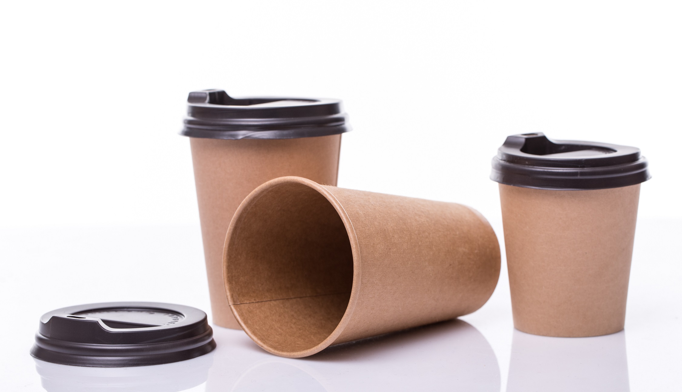 covered Paper coffee cups different sizes isolated on white